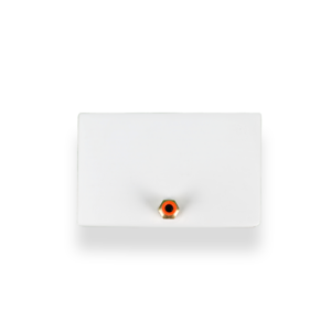 Close-up of a white electrical junction box with a brass conduit fitting in the center and an orange ring around the hole