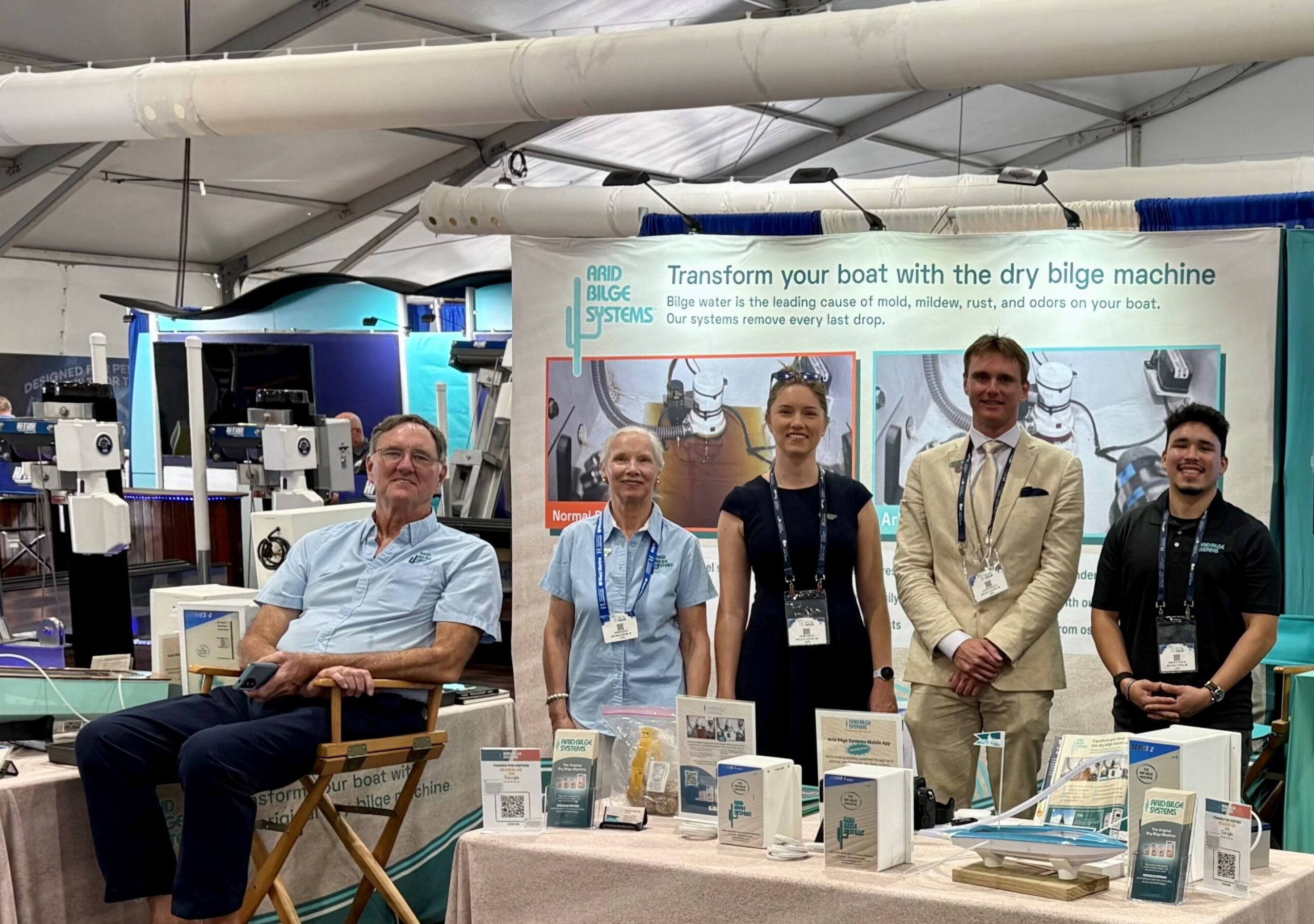 Team Arid at FLIBS 2024 Five people smiling at a trade show booth