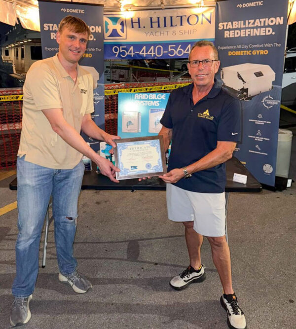 Alfred Baurley and Steve Gilchrist of Straight Up Marine holding an Arid Bilge Systems Certificate of Authenticity.