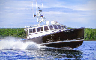 FV-TUNA.COM fishing boat underway, viewed from the bow quarter.