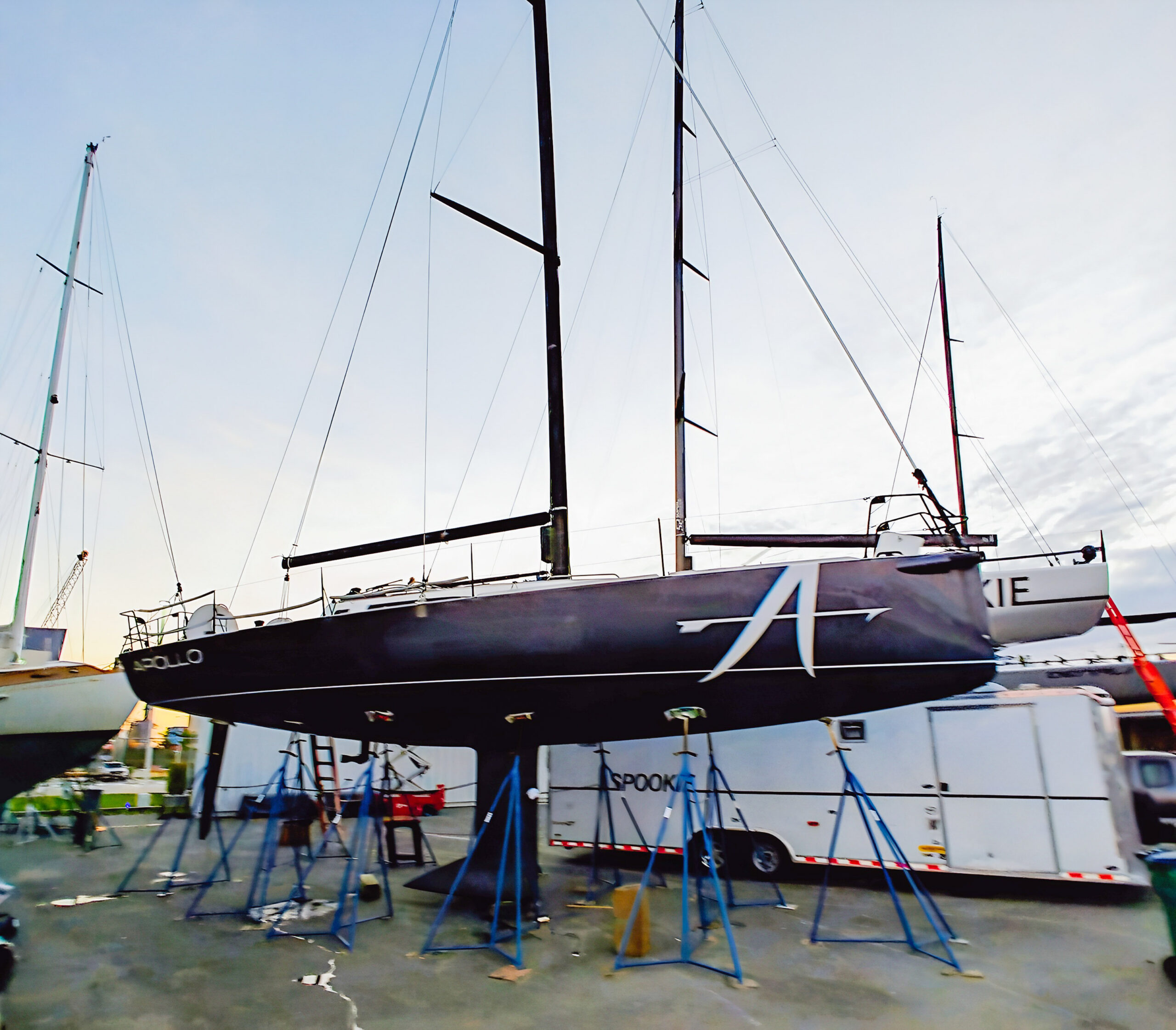 apollo-j121-original-exterior - Arid Bilge Systems Apollo sailboat on boatyard supports with its name and large A hull graphic visible.