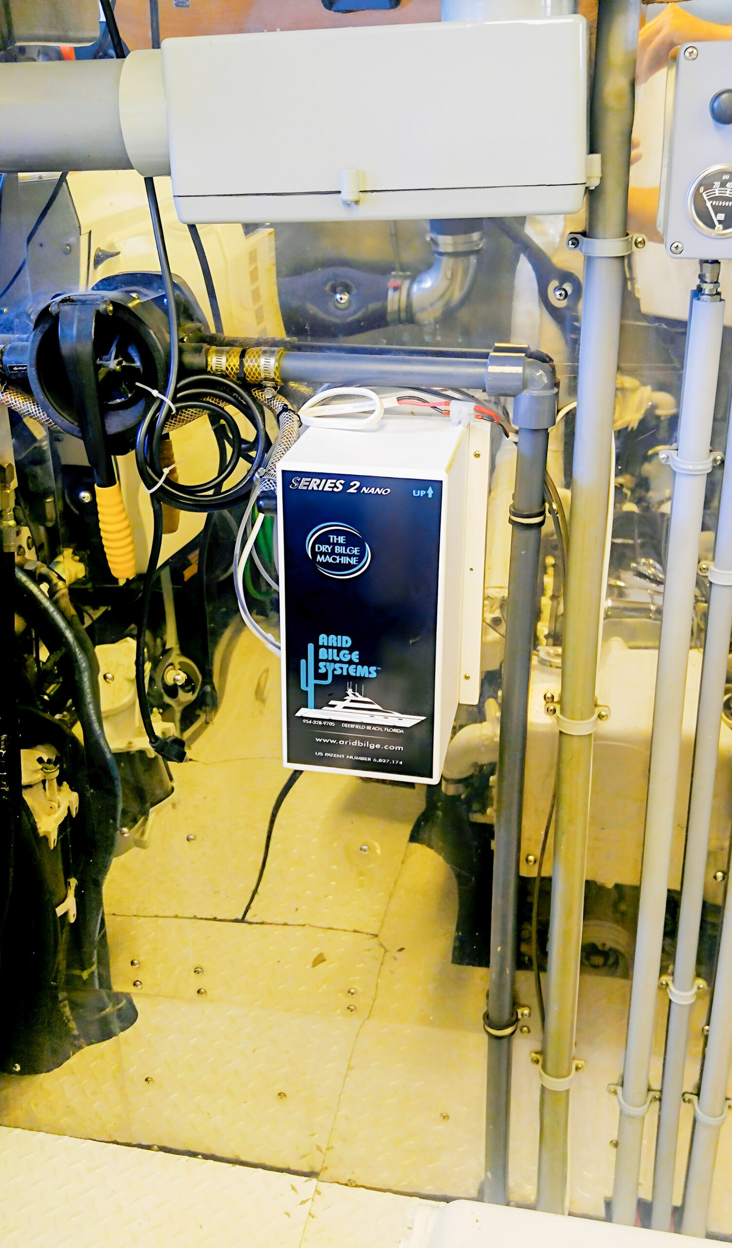 Arid unit labeled Series 2 Nano installed aboard Flying Lady, beside pipes and service equipment.