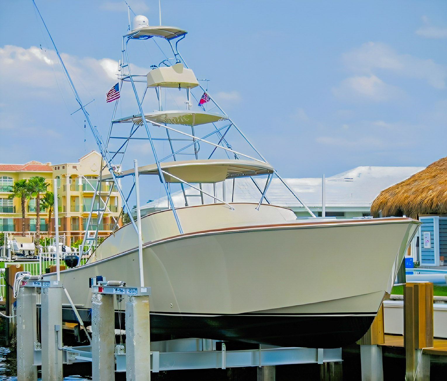 Longer Hours — Gillikin sportfish on a boat lift - Arid Bilge Systems Longer Hours, a 36-foot Gillikin sportfish with a tall tower, on a boat lift.