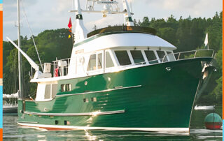 Spirit of Zopilote, a green-hulled trawler with a white wheelhouse and tall mast, alongside a mooring.